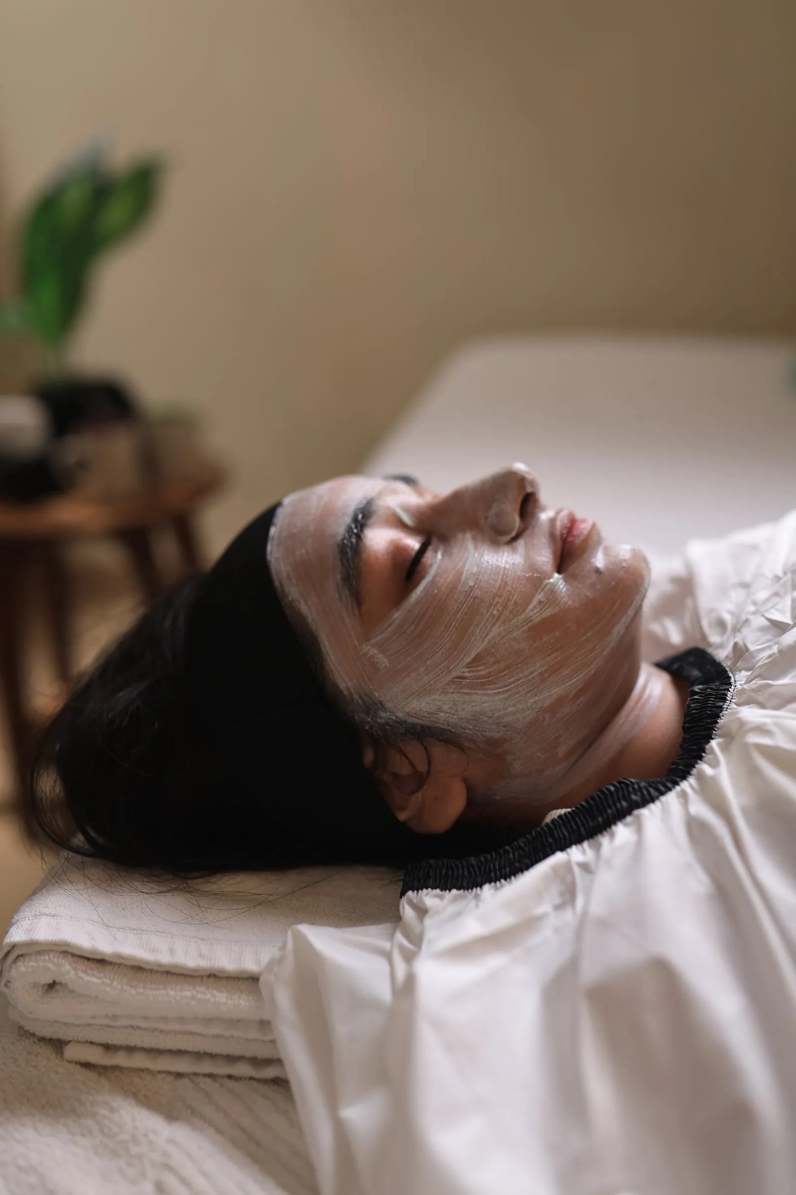 Woman with face mask lying down, technician's hands